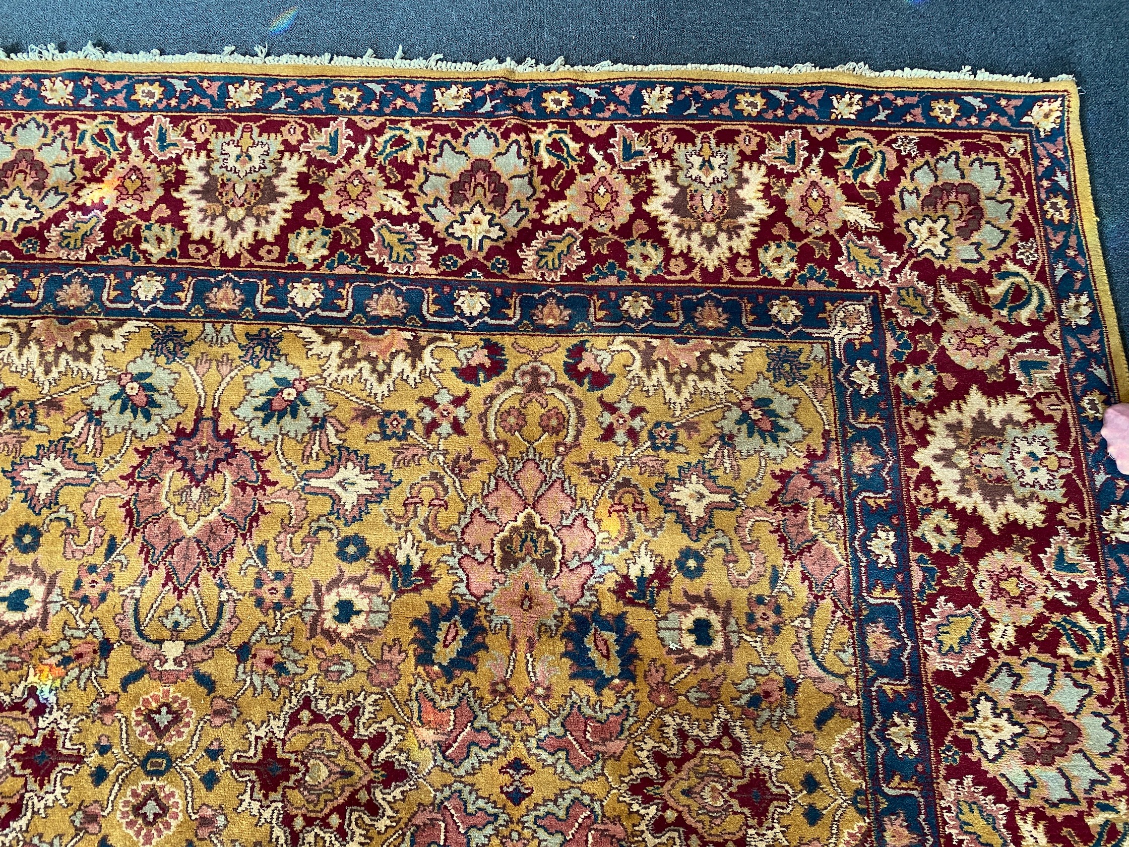 An Agra gold ground carpet with dense palmette field and wide conforming border 360 x 280 cms